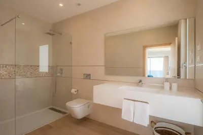 a bathroom with a sink and a toilet and a shower at Beach View Villa by Blue Diamond 55 in Lagos