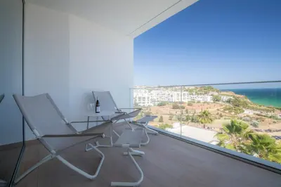 a room with a desk and chairs and a view of the ocean at Beach View Villa by Blue Diamond 55 in Lagos