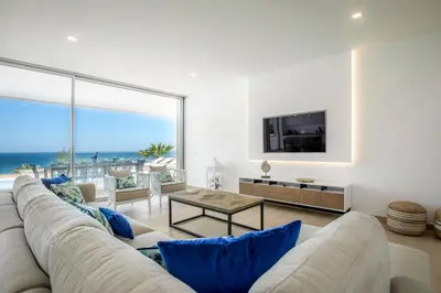 a living room with a large couch and a television at Beach View Villa by Blue Diamond 55 in Lagos