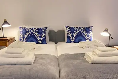 two beds sitting next to each other with towels on them at CHC Rochinha in Funchal