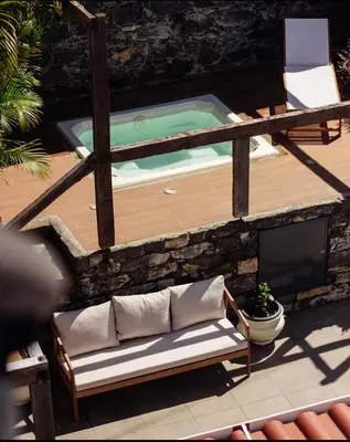 a bench sitting in front of a swimming pool at CHC Rochinha in Funchal