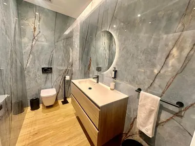 a bathroom with a sink and a toilet and a mirror at Blue Boat by Madeira Best Apartments in Funchal