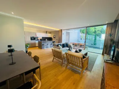 a living room with a couch and a table and chairs at Blue Boat by Madeira Best Apartments in Funchal
