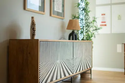 a wooden cabinet in a living room with a lamp at Blue Boat by Madeira Best Apartments in Funchal