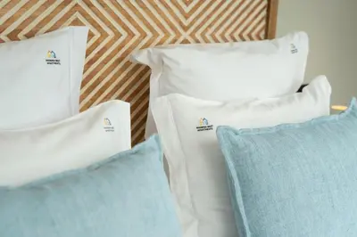 three white pillows sitting next to each other at Blue Boat by Madeira Best Apartments in Funchal