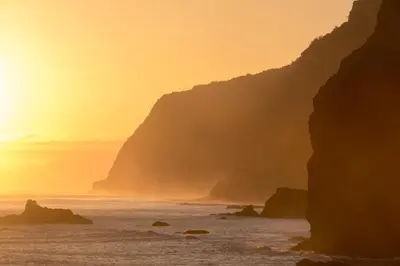 a sunset over the ocean with cliffs in the background at CASAS MARE , Ponta Delgada, Madeira in Ponta Delgada
