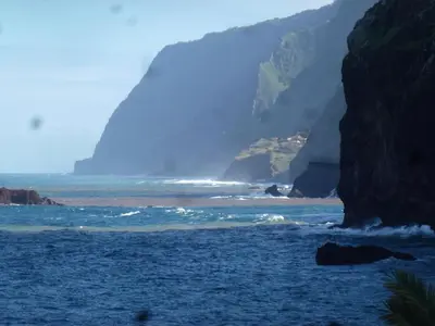 a view of the ocean with a mountain in the background at CASAS MARE , Ponta Delgada, Madeira in Ponta Delgada