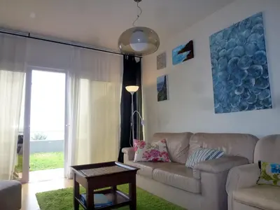 a living room with a couch and a window at CASAS MARE , Ponta Delgada, Madeira in Ponta Delgada