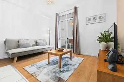 a living room with a couch and a table at Cozy City Center Apartment in Funchal in Funchal