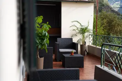 a balcony with chairs and plants on a building at Vila Verde in Tábua