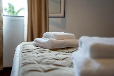 a pile of towels sitting on top of a bed at Vila Verde in Tábua
