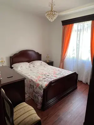 a bedroom with a bed and a table and a window at Casa Nova - Maison avec garage, terrasse & Balcon in Ponta do Sol