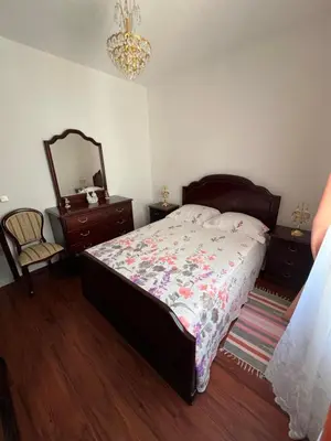 a bedroom with a bed and a dresser and a mirror at Casa Nova - Maison avec garage, terrasse & Balcon in Ponta do Sol