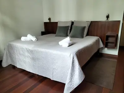 a bedroom with a bed with two pillows on it at Hortasol A in Funchal