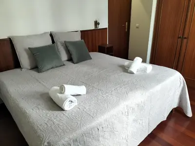 a white bed with two rolls of towels on it at Hortasol A in Funchal
