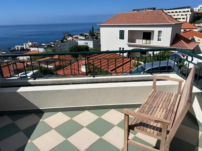 a bedroom with a bed with a towel on it at Maribel's Place in Funchal