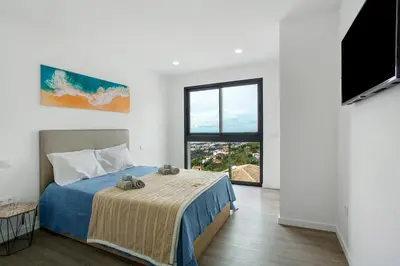 a bedroom with a bed with two stuffed animals on it at Villa Angela in Funchal