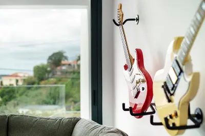 two guitars hanging on a wall next to a window at Villa Angela in Funchal