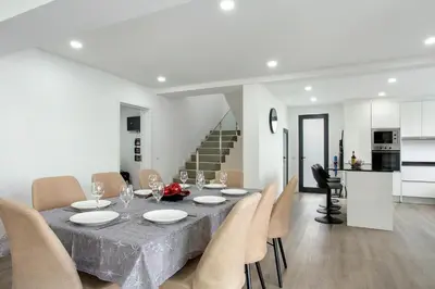 a dining room with a table and chairs at Villa Angela in Funchal