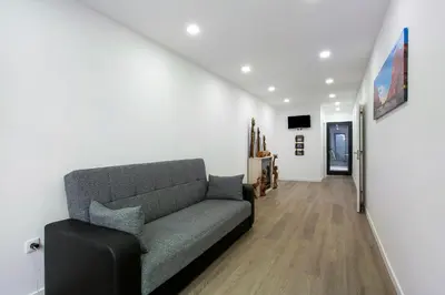 a living room with a couch and a television at Villa Angela in Funchal