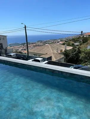 a swimming pool with cars parked on top of it at Villa Angela in Funchal