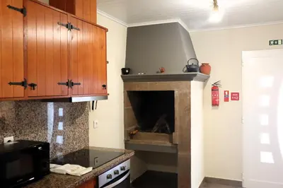 a kitchen with a fire place in the wall at Casa Vicente II, By OP in Boaventura