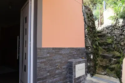 an open door to a brick wall with a stone staircase at Casa Vicente II, By OP in Boaventura