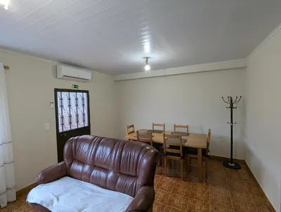 a living room with a leather couch and a table at Casa Vicente II, By OP in Boaventura