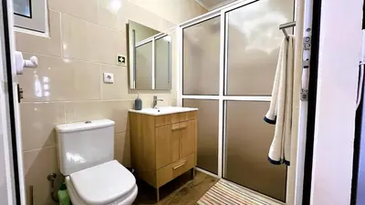 a bathroom with a toilet and a sink and a shower at Casa Vicente II, By OP in Boaventura