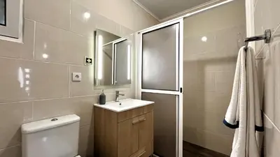 a bathroom with a toilet and a sink and a mirror at Casa Vicente II, By OP in Boaventura