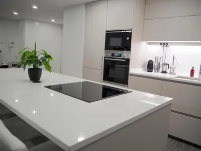 a kitchen with a white counter top with a plant at Imperatriz Madeira Apartment in Funchal