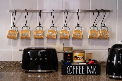 a kitchen counter with a toaster and a coffee bar at Sallys in Ponta do Sol