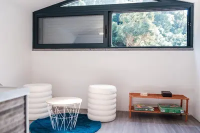 a room with a window with two chairs and a table at GuestReady - Tranquil Hideaway near Funchal in Funchal