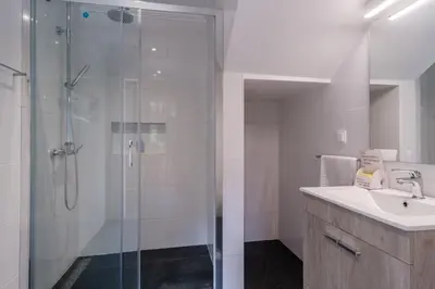 a bathroom with a glass shower and a sink at GuestReady - Tranquil Hideaway near Funchal in Funchal