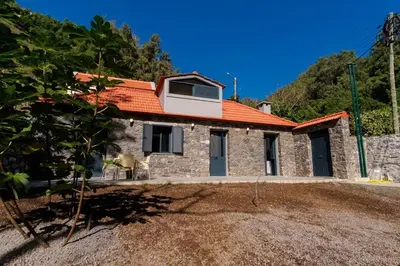 a stone house with an orange roof at GuestReady - Tranquil Hideaway near Funchal in Funchal