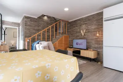 a living room with a table and a tv at GuestReady - Tranquil Hideaway near Funchal in Funchal