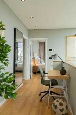 a hotel room with a desk and a bedroom at Green Boat by Madeira Best Apartments in Funchal