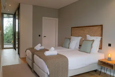 a bedroom with a large bed with white pillows at Green Boat by Madeira Best Apartments in Funchal