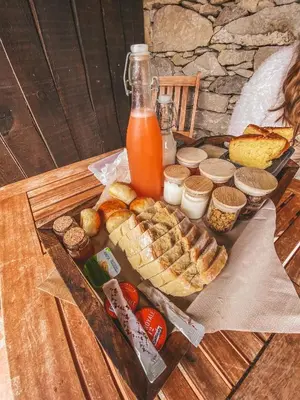 a tray of bread and juice and other food on a table at Alojamento Casas da Serra in Porto Santo
