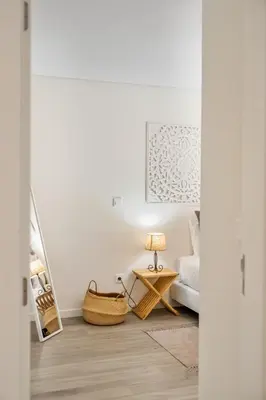 a living room with a bed and a table with a lamp at Carmo Heritage Apartments in Funchal