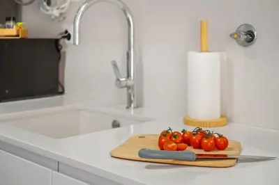a bunch of tomatoes on a cutting board on a kitchen counter at Carmo Heritage Apartments in Funchal
