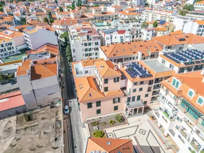 an aerial view of a city with orange roofs at Carmo Heritage Apartments in Funchal