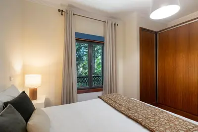 a bedroom with a large bed and a window at Arriaga Residence I by An Island Apart in Funchal