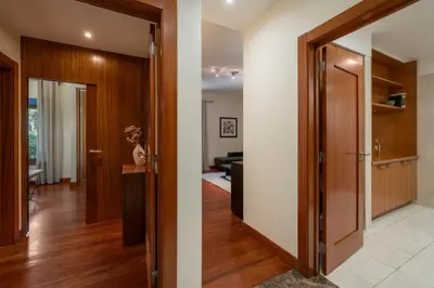 a hallway leading into a living room with a door at Arriaga Residence I by An Island Apart in Funchal