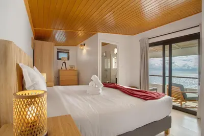 a bedroom with a bed with a view of the ocean at The Yellow House in Jardim do Mar