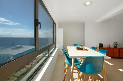 a dining room with a view of the ocean at The Yellow House in Jardim do Mar
