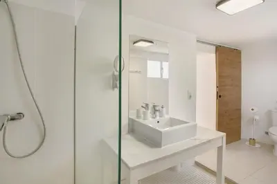 a bedroom with a white bed and a window at The Yellow House in Jardim do Mar