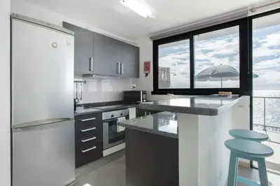 a kitchen with a refrigerator and a counter top at Original Wave House in Jardim do Mar