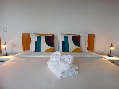 a bathroom with a shower with a mirror and blue tiles at The Wave House - Two Bedroom Flat in Jardim do Mar