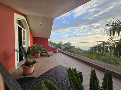 a balcony of a house with plants on it at Villa River Ponta do Sol by Rentallido in Canhas